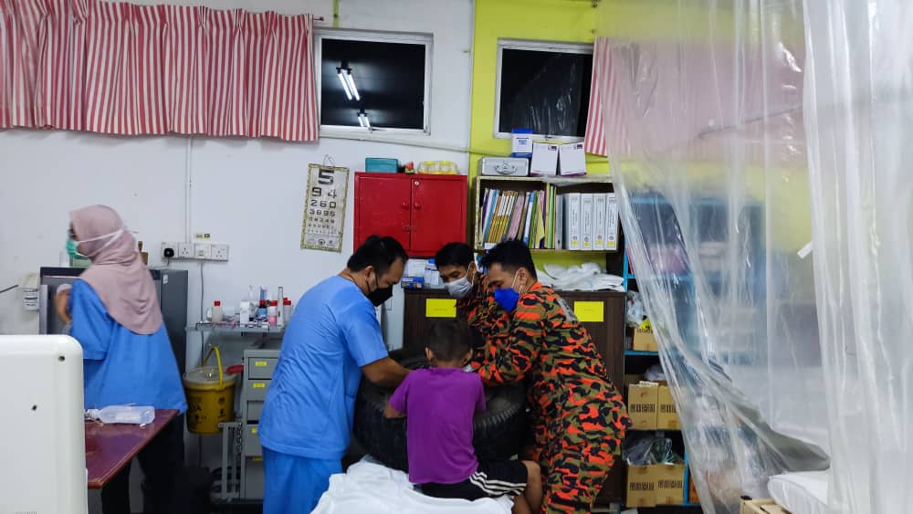 Pasukan Bomba bertindak membuka jari seorang kanak-kanak lelaki tersangkut di dalam rim kenderaan di hospital Kota Marudu semalam. - Foto Ihsan JBPM Sabah