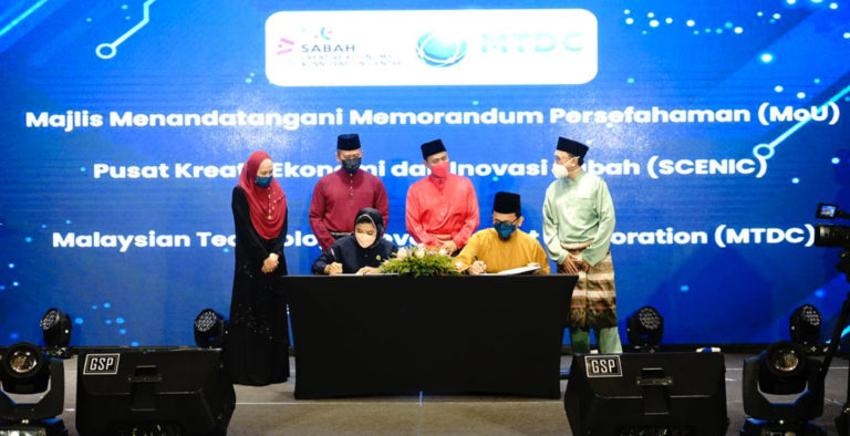 Pengurus besar SCENIC Viviantie Sarjuni bertukar dokumen dengan Ketua Pegawai Eksekutif MTDC, Dato Norhalim Yunus selepas menandatangani Memorandum Persefahaman. - Foto ihsan KSTI